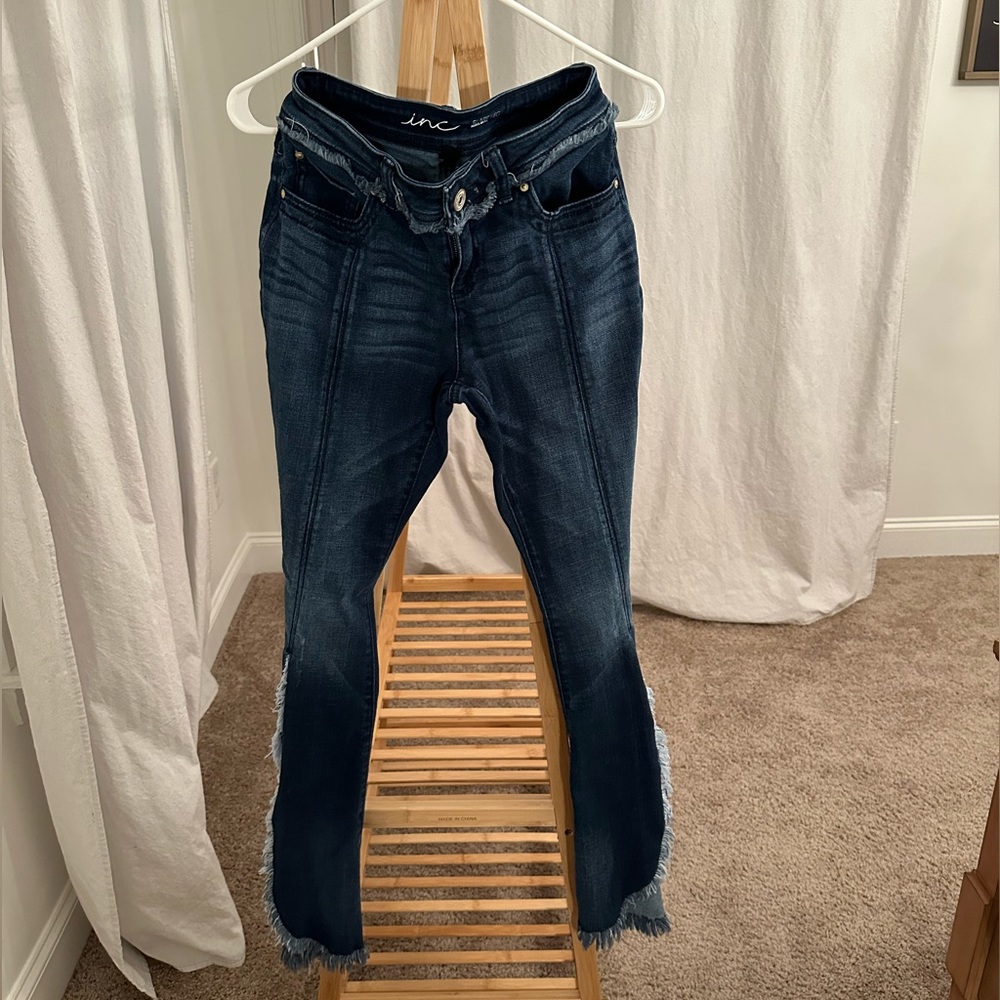 Flare jeans. Slit on leg with cute design.